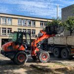 Large orange truck outside residential buildings